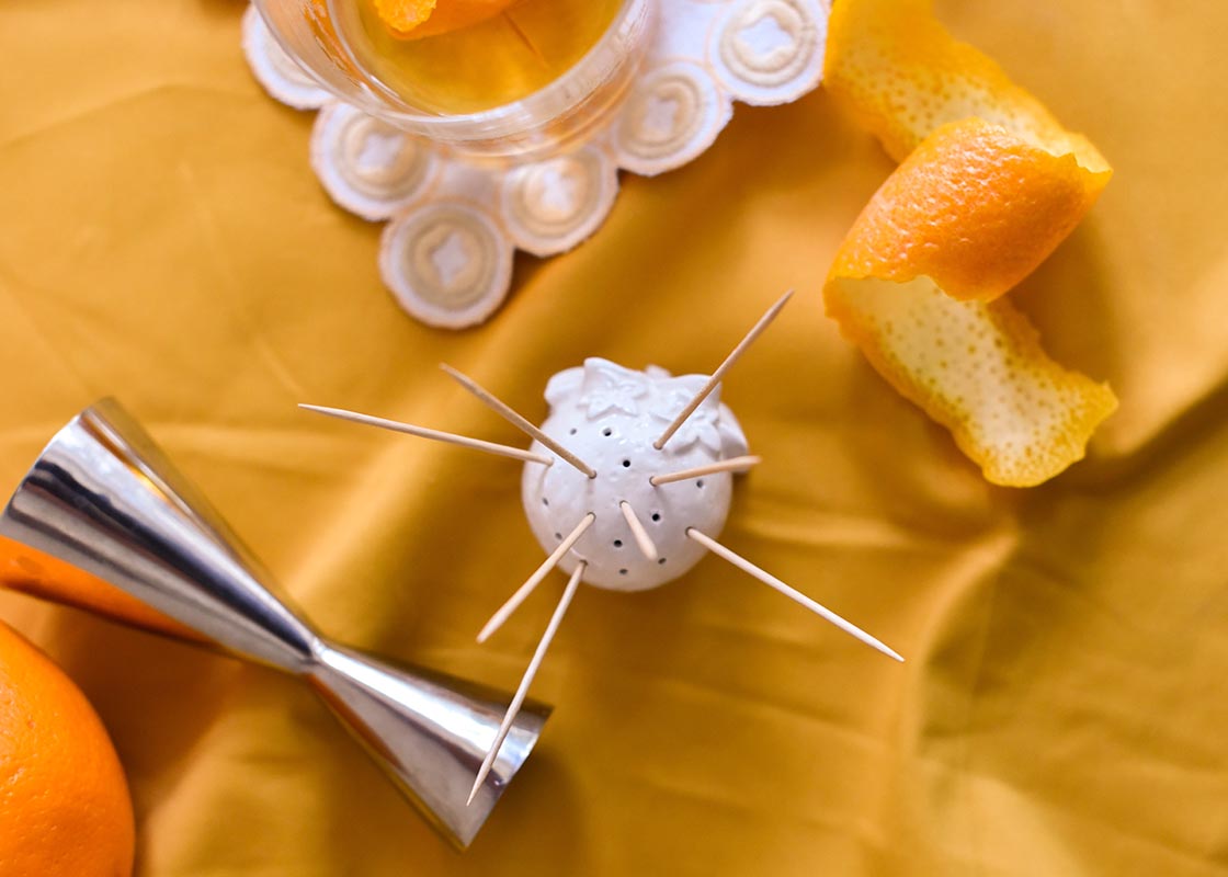 Close up of Orange Toothpick Holder with Carved Orange Blossoms