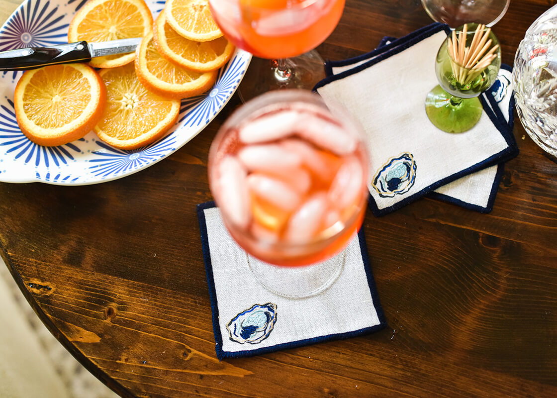 Overhead View of Happy Hour with Essential Cocktail Napkin Oyster Design