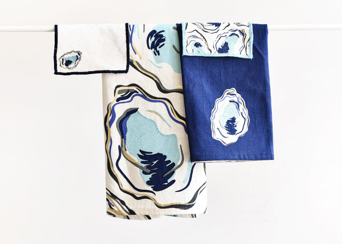 Front View of Oyster Linen Collection Including Large Hand Towel Folded and Hanging on Rod