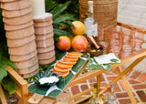 Tablescape with Coordinating Palm Designs Including Large Rectangle Board