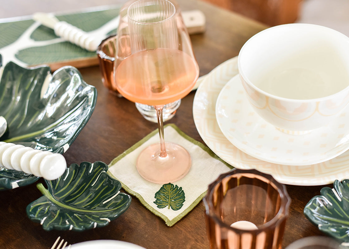 Front View of Palm Cocktail Napkin with Green Embroidery in Tablescape