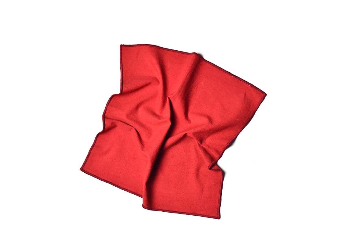 Overhead View of Crumpled Napkin Red Color Block Napkin Showcasing Texture and Personality