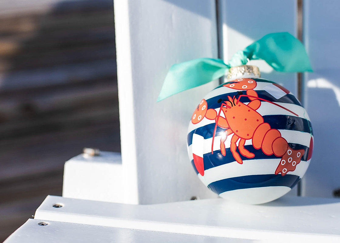 Front View of Colorful Lobster on Blue Striped Ornament Placed on Adirondack Chair