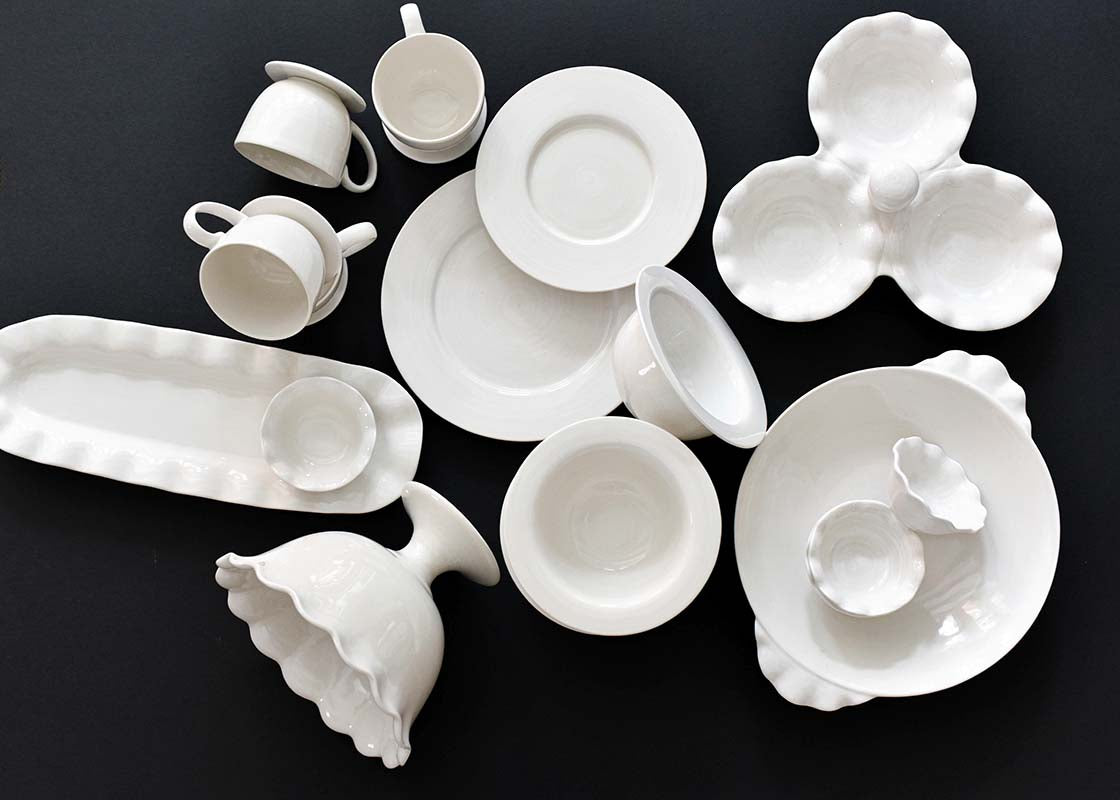 Overhead View of Signature White Collection Including Ruffle Pasta Bowl on Black Background
