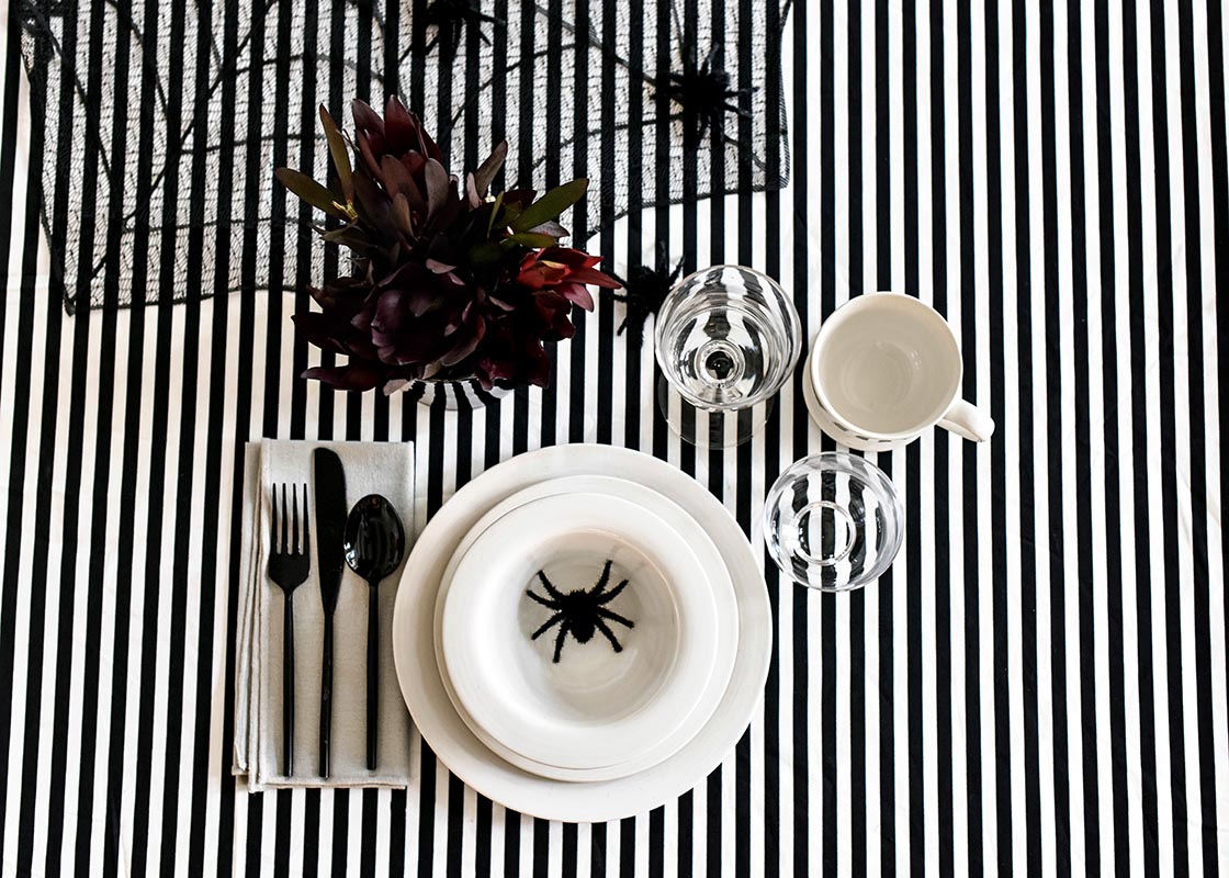 Overhead View of Individual Place Setting with Signature White Rimmed Small Bowl in Halloween Tablescape