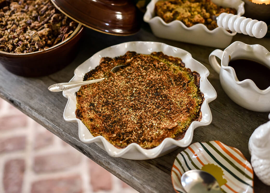 Cropped Close up of Pumpkin Pie in Signature White 9in Ruffle Pie Dish on Thanksgiving Buffet