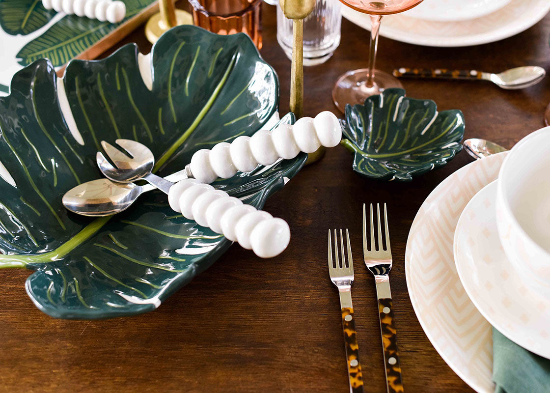 Close up of Coton Colors Serveware Including White Knob Serving Spoon In Palm Inspired Tablescape
