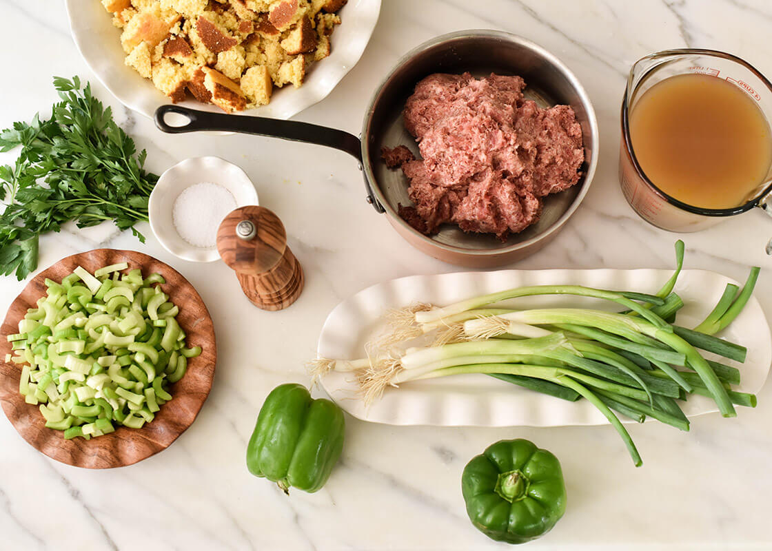 Overhead View of Coordinating Bowls and Platters Including Signature White Ruffle Skinny Tray Filled with Ingredients for Cooking