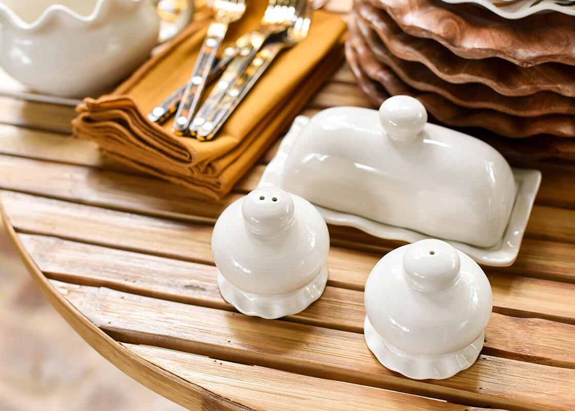 Cropped Close up of Stacks of Dishware and Signature White Ruffle Domed Butter Dish