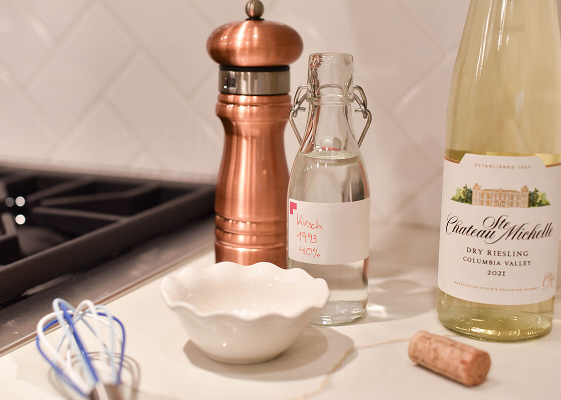 Right Side View of Signature White Ruffle Dipping Bowl next to Cooktop and Ingredients