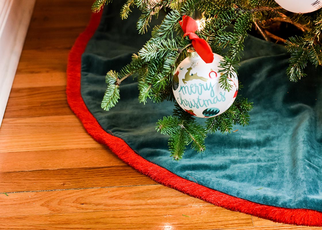 Front View of Christmas Decor Including Pine Velvet Tree Skirt with Red Trim