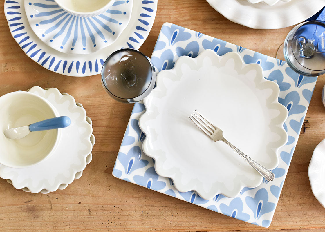 Cropped Close up of Iris Blue Sprout Square Platter Paired with Signature White Ruffle Dinnerware