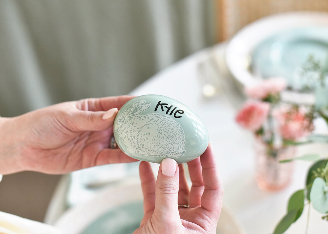 Front View of Holding a Speckled Rabbit Egg from Set of 2 Personalized with the name Kyle to use as Place Cards on Easter Table