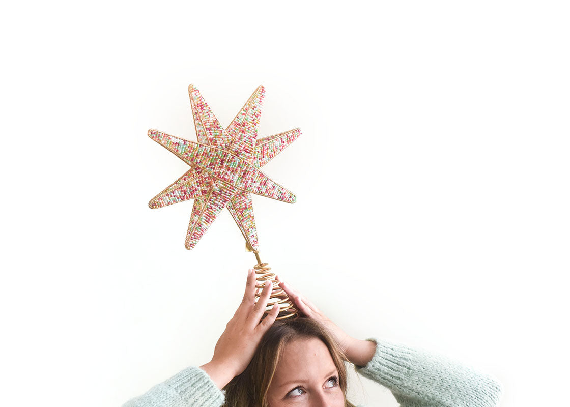 Cropped View of Woman Holding Multi Beaded Star Large Tree Topper on Top of Head