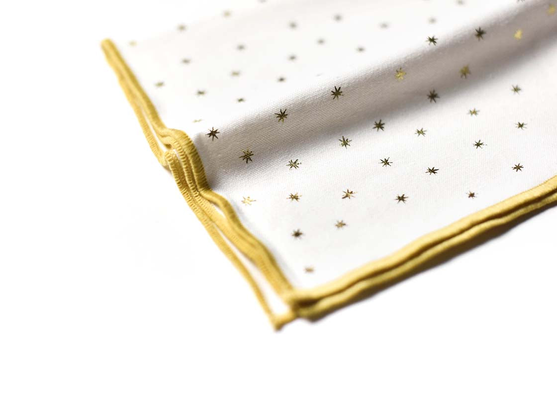 Cropped Close up of Gold Hem Stitched Edge on Folded Gold Stars Napkin Set of 4 Showcasing Beautiful Texture of Fabric