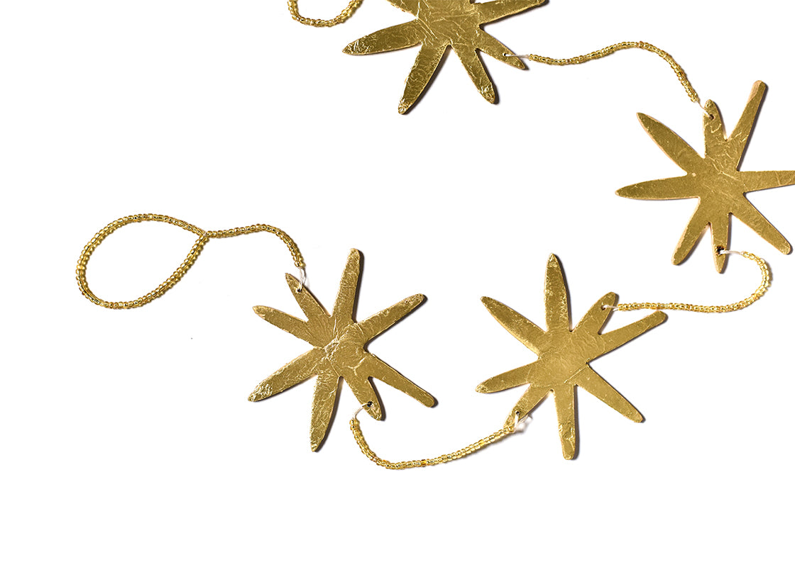 Cropped Close up of Detailed Gold Stars and Beading on Gold Star Garland