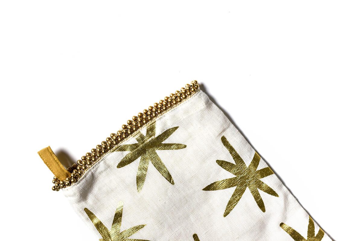 Cropped Close up of Loop Hanger and Trim on Gold Stars Stocking with Beaded Trim Showcasing Beautiful Texture of Fabric