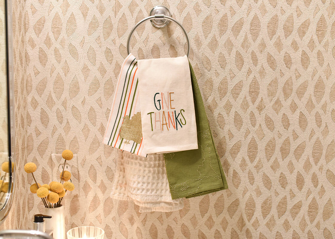 Front View of Turkey Stripes Medium Hand Towel Layered with Thanksgiving Themed Towels