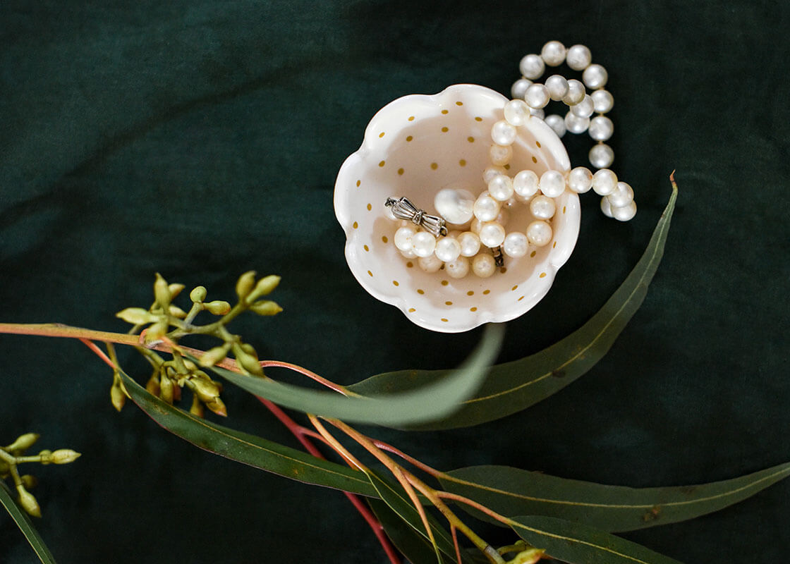 Overhead View of Gold Swiss Dot Scallop Ring Dish Holding Jewelry